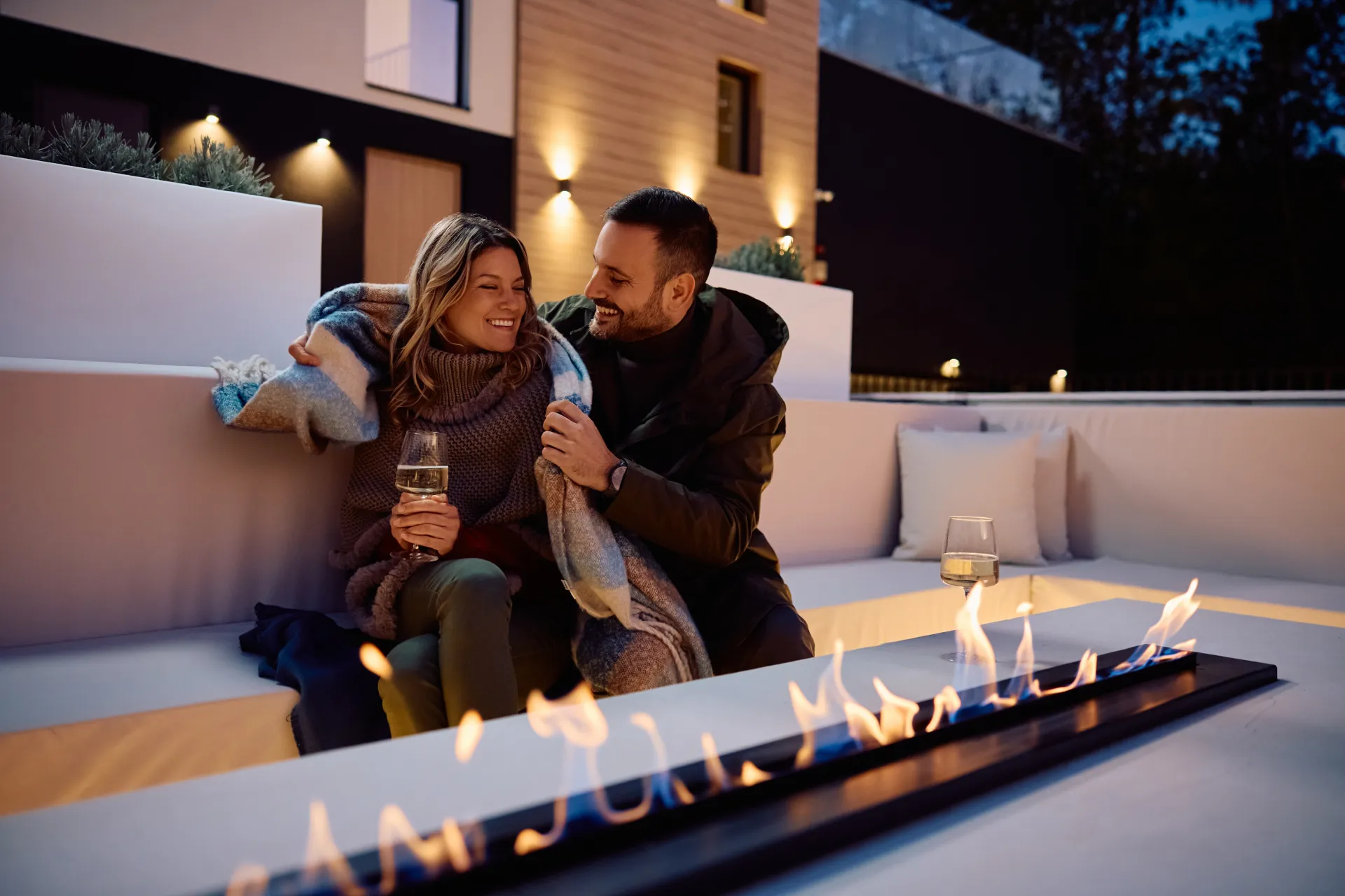 Couple gathered around a fire pit at twilight