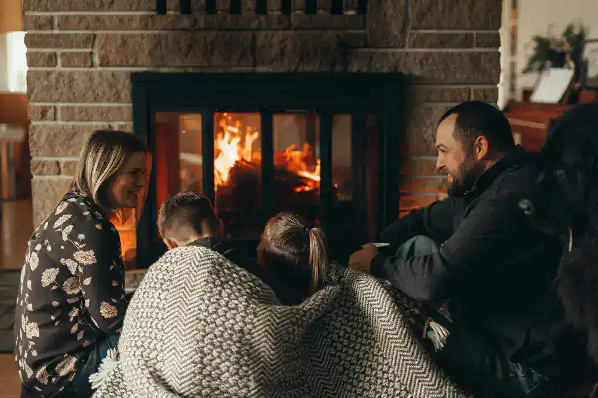 Family gathered around fireplace